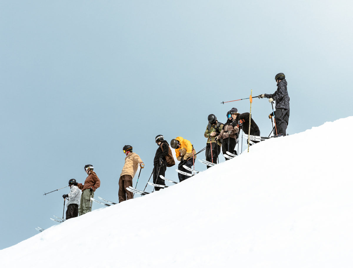 RMU team lined up along a mountain ridge above the resort